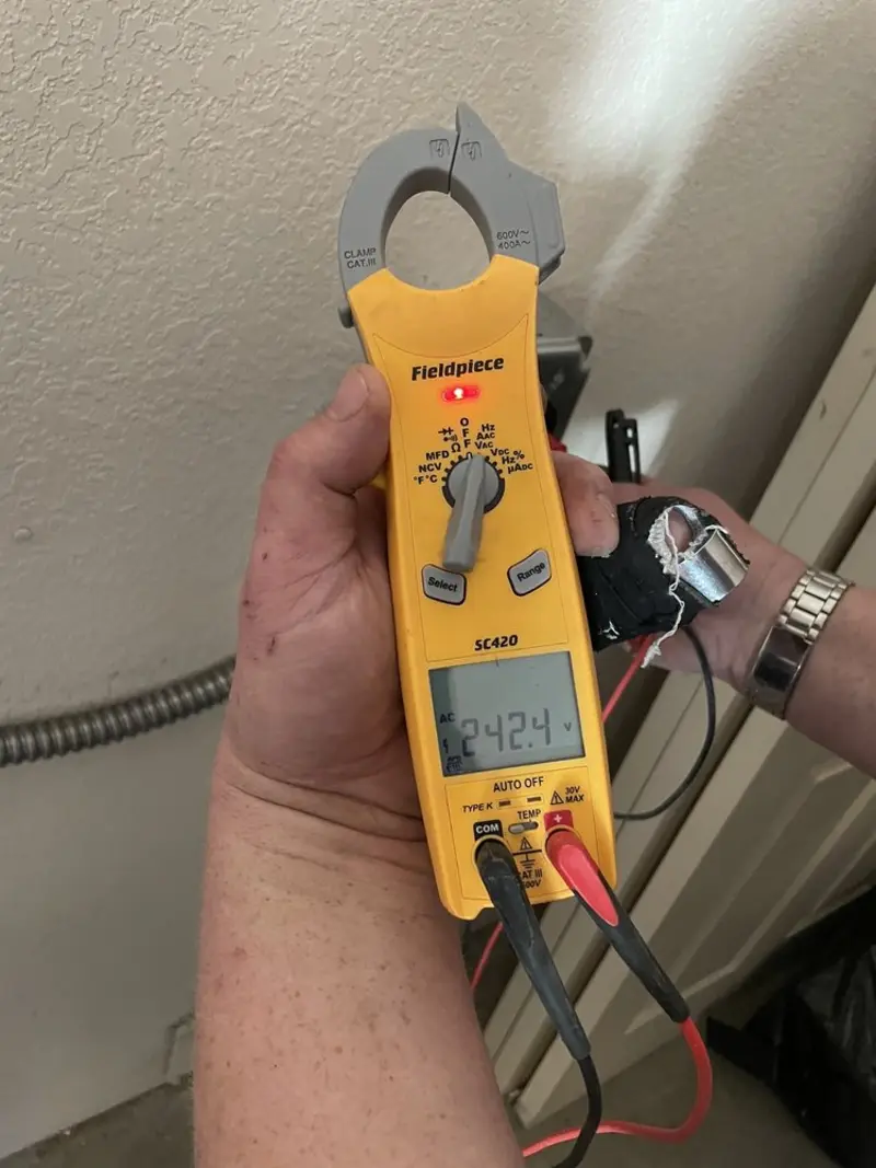 Voltage testing with clamp meter during Ceiling Fan Installation in North Collins